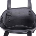 Close-up of a black tote handbag with carabiner key clip and rivet ad stitch details 